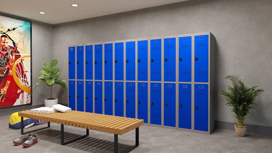 Blue lockers in a modern gym setting with a wooden bench.